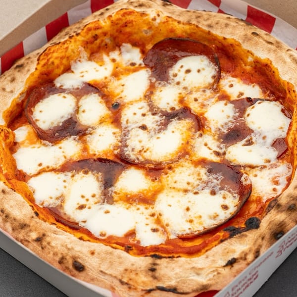 Captain's Pizza Company pepperoni pizza with melted mozzarella cheese in a takeout box.
